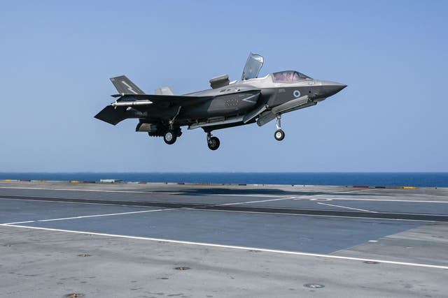 <p>An F-35 fighter jet prepares to land on the flight deck of HMS Queen Elizabeth </p>