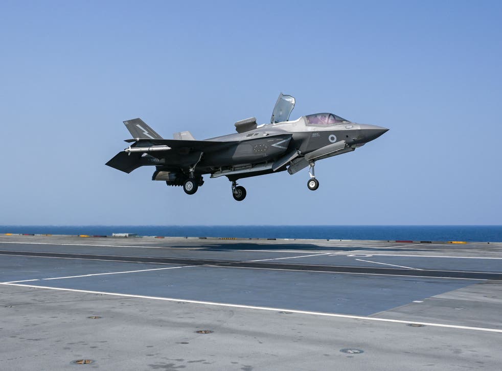<p>An F35 fighter jet prepares to land on the flight deck of HMS Queen Elizabeth last month</p>