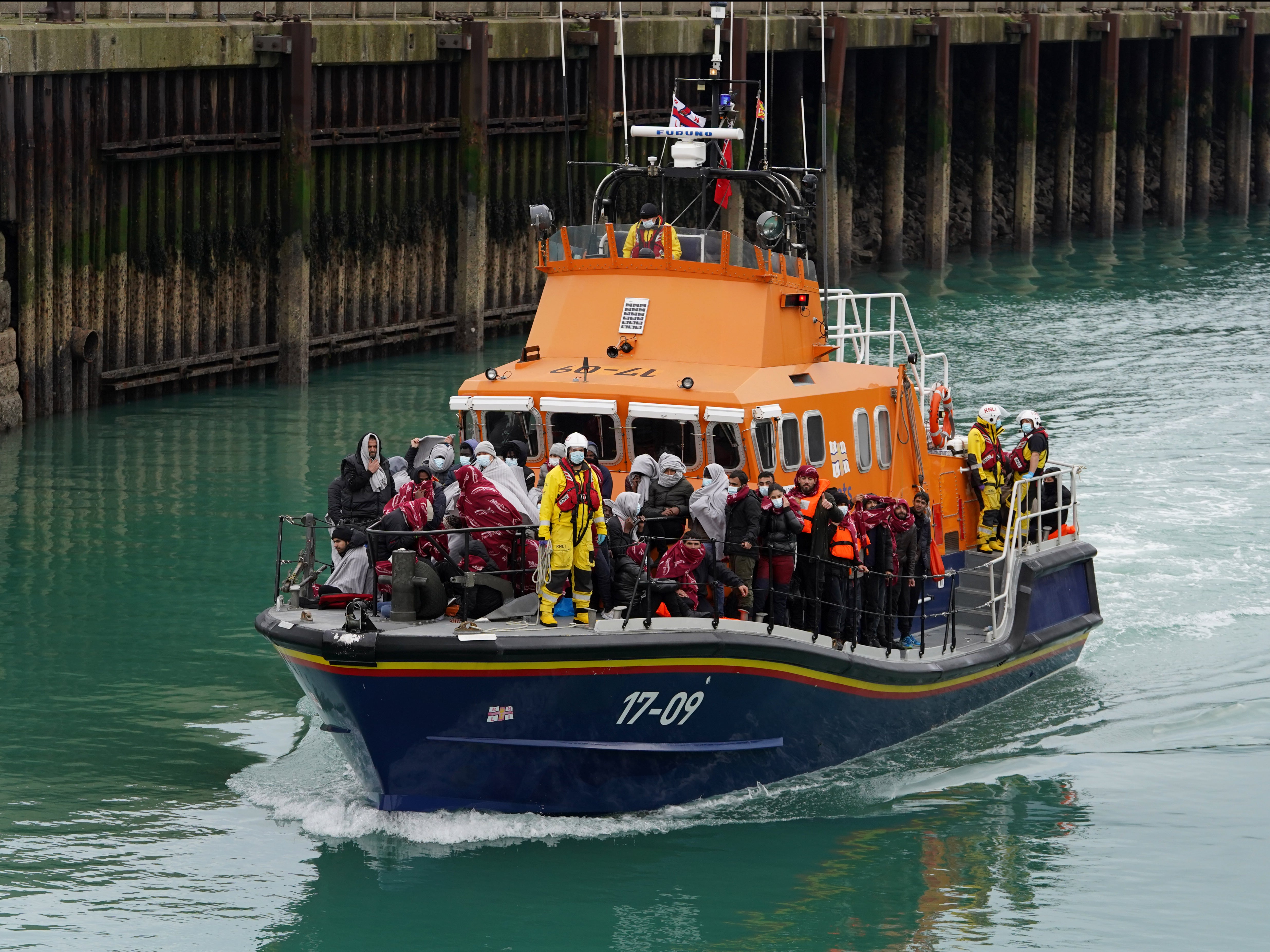 A group of people believed to be migrants intercepted in the Channel are brought into Dover by a lifeboat