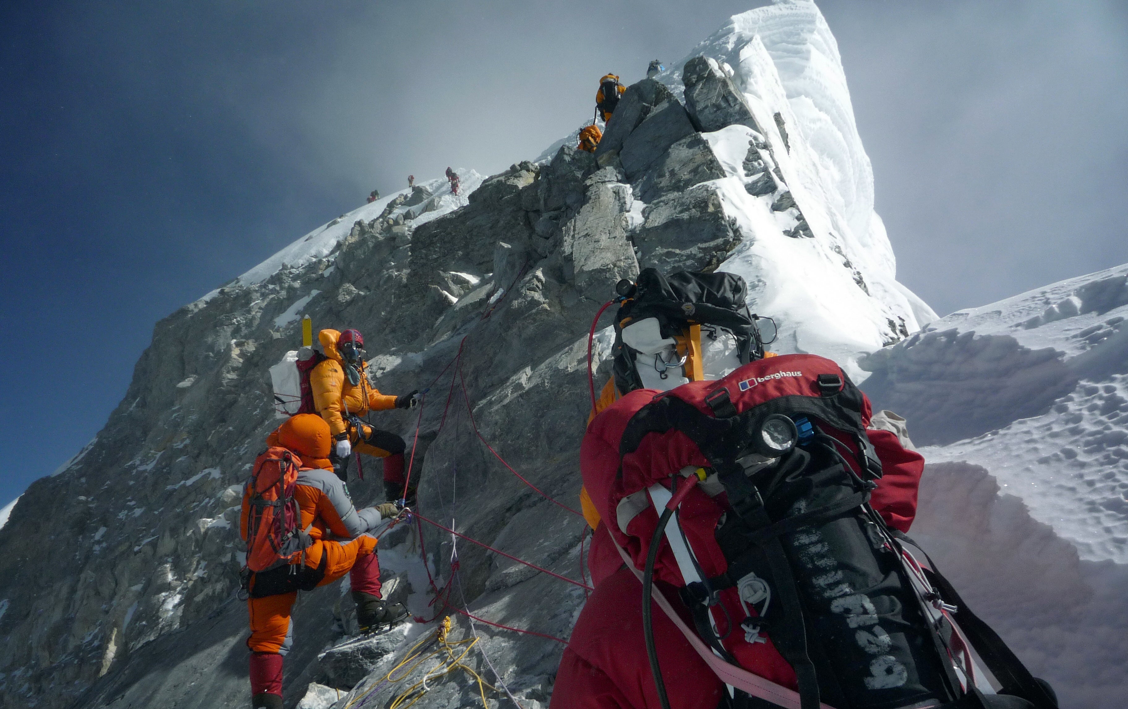 Mountaineers head past the Hillary Step on the way to the summit of Everest during a high-risk attempt