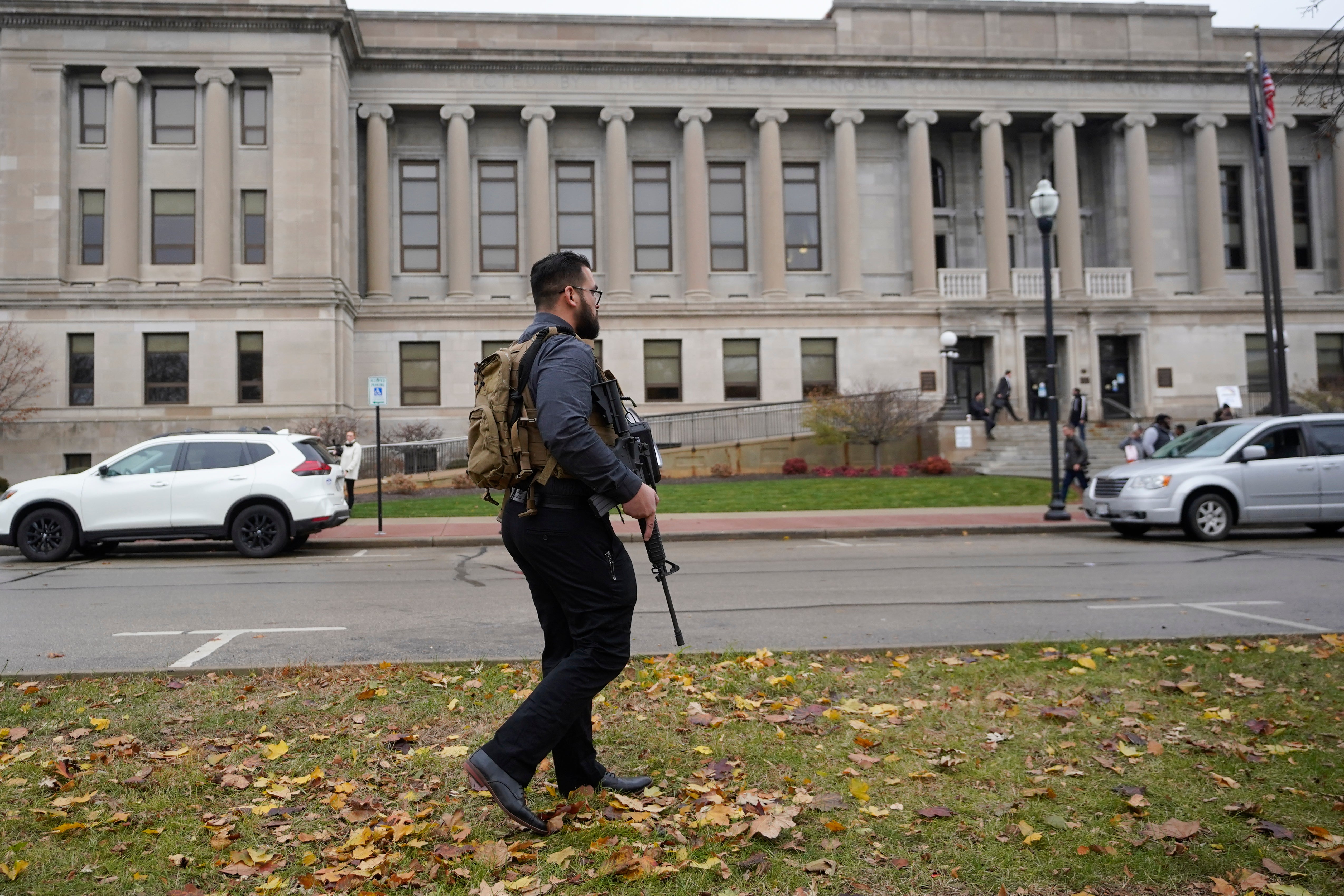 The man carrying a rifle outside the Kenosha County Courthouse where the jury continues deliberations