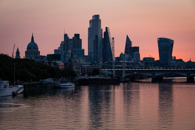 Early morning light bathes the skyscrapers of the City of London financial district (Aaron Chown/PA)