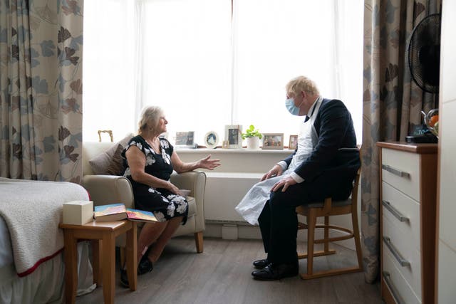 <p>Boris Johnson talks to care home resident Kathleen in Stepney Green, London, in September</p>