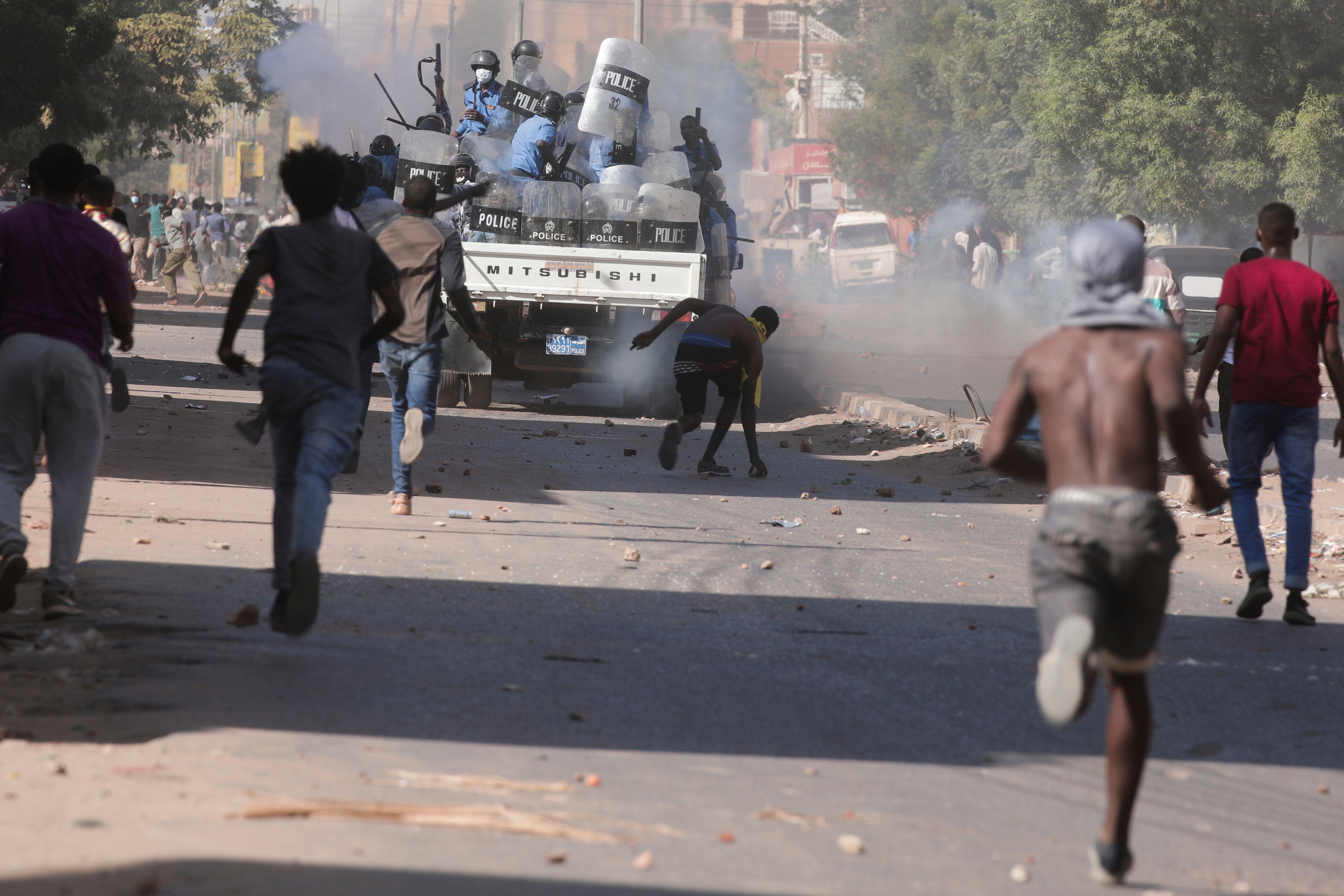 Sudanese anti-coup protesters confront the police in Khartoum