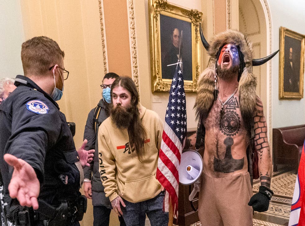 <p>Jacob Chansley screams as he and other intruders maraud through the US Capitol on 6 January, 2021 </p>