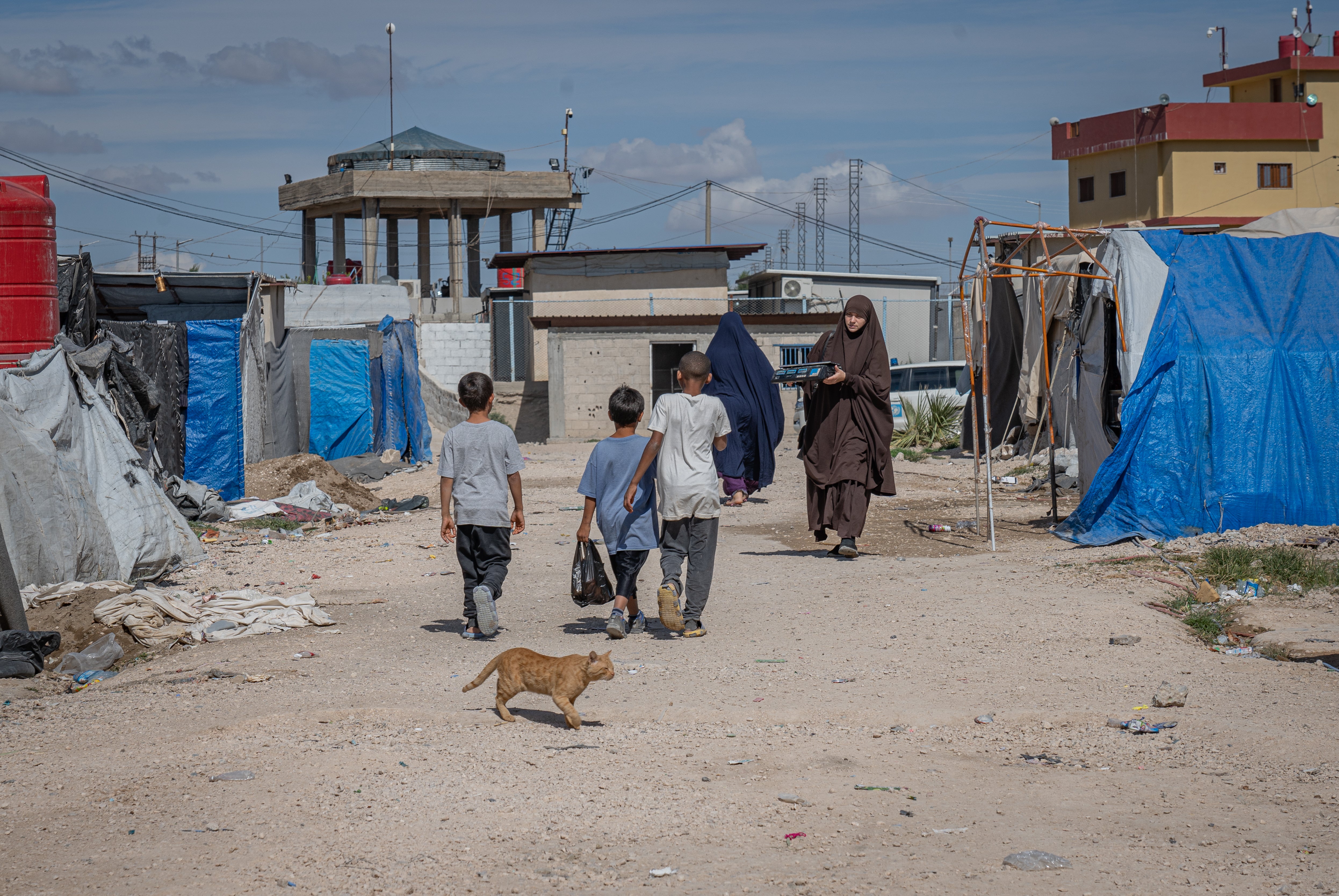 Children walk through Roj camp in northeast Syria