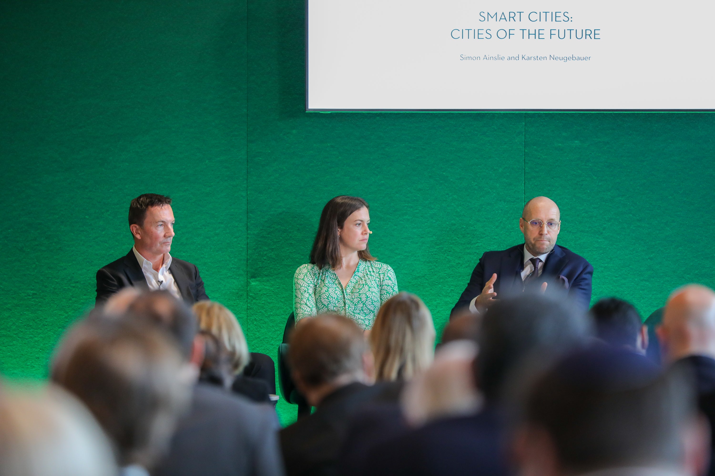 Simon Ainslie (left) and Karsten Neugebauer (right) discuss the future of urban living during a panel moderated by Isabel Hardman (centre) on smart cities at the Saudi Green Initiative London summit at Waddesdon Manor