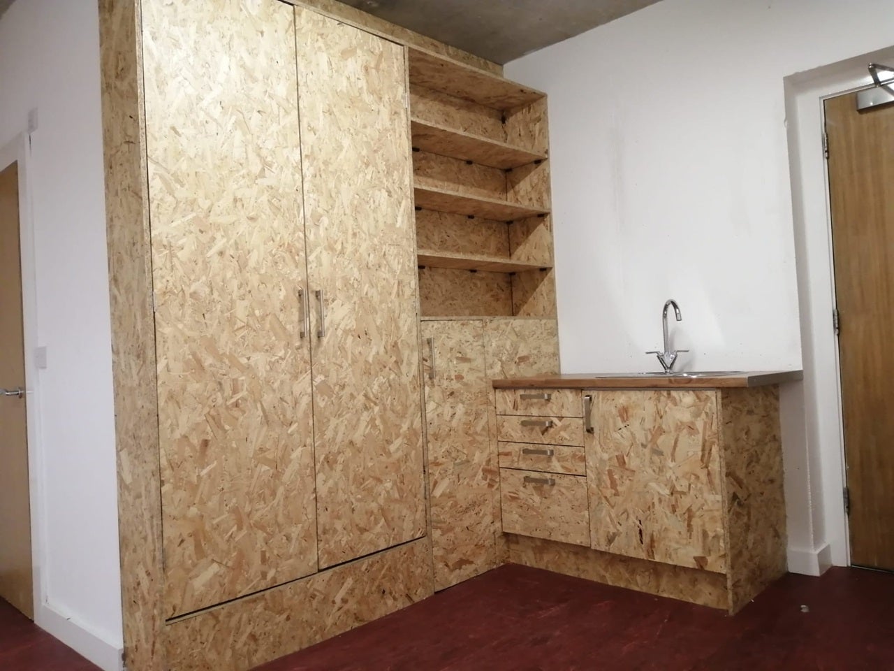 The property features floor-to-ceiling chipboard