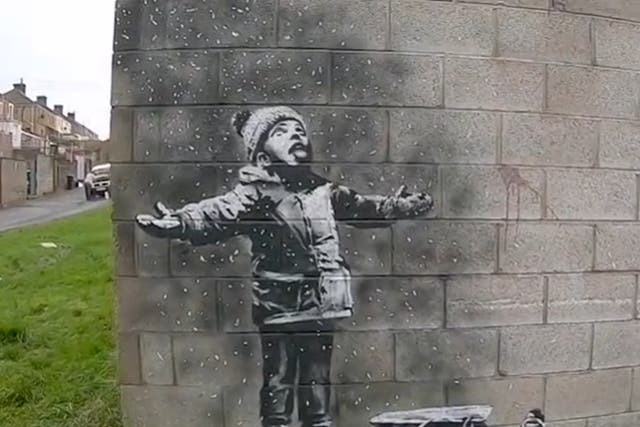 <p>One half of the ‘Season’s Greetings’ mural, as filmed by Banksy in 2018</p>