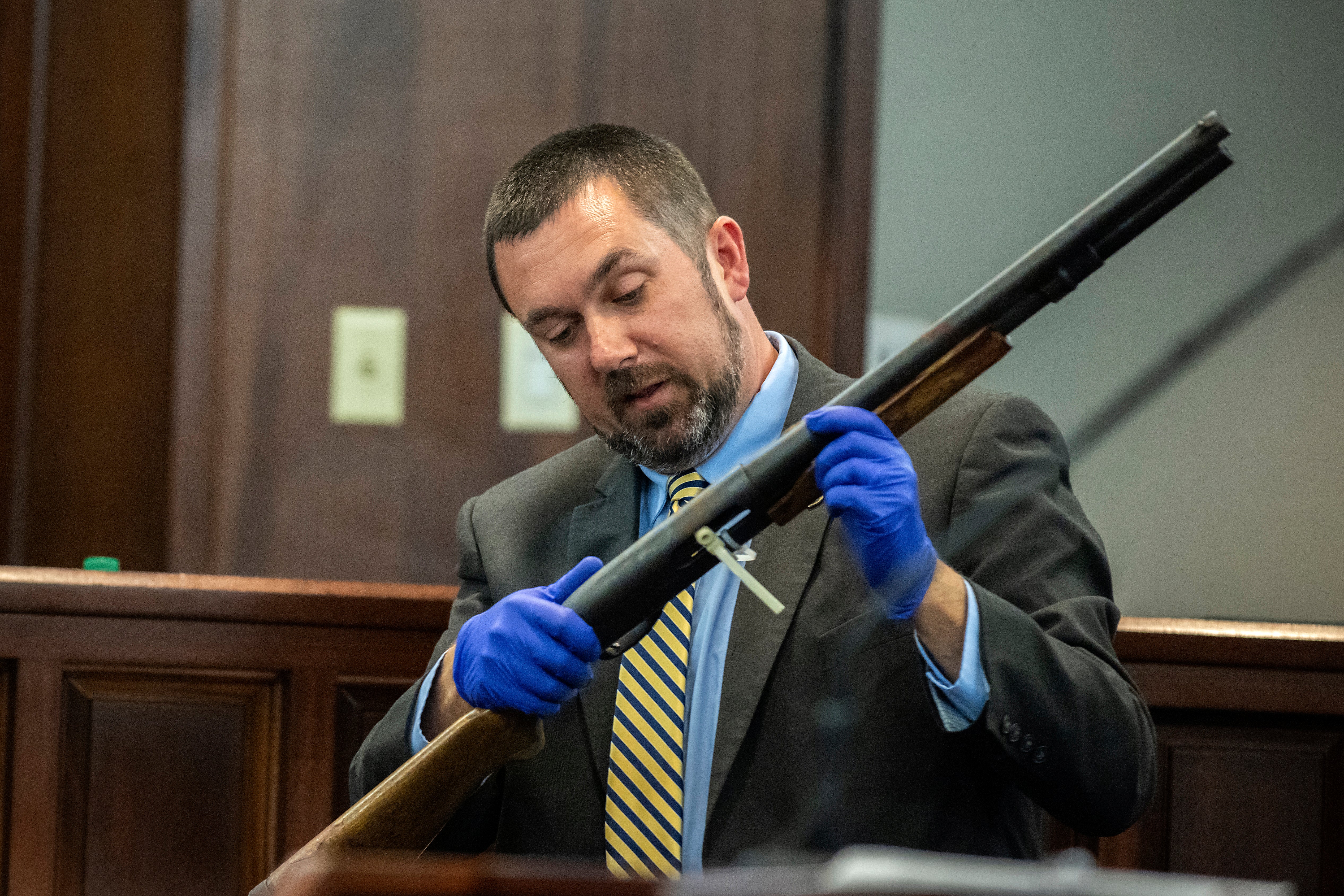 The shotgun used to kill Ahmaud Arbery is seen during the trial of Gregory and Travis McMichael and William “Roddie” Bryan Jr