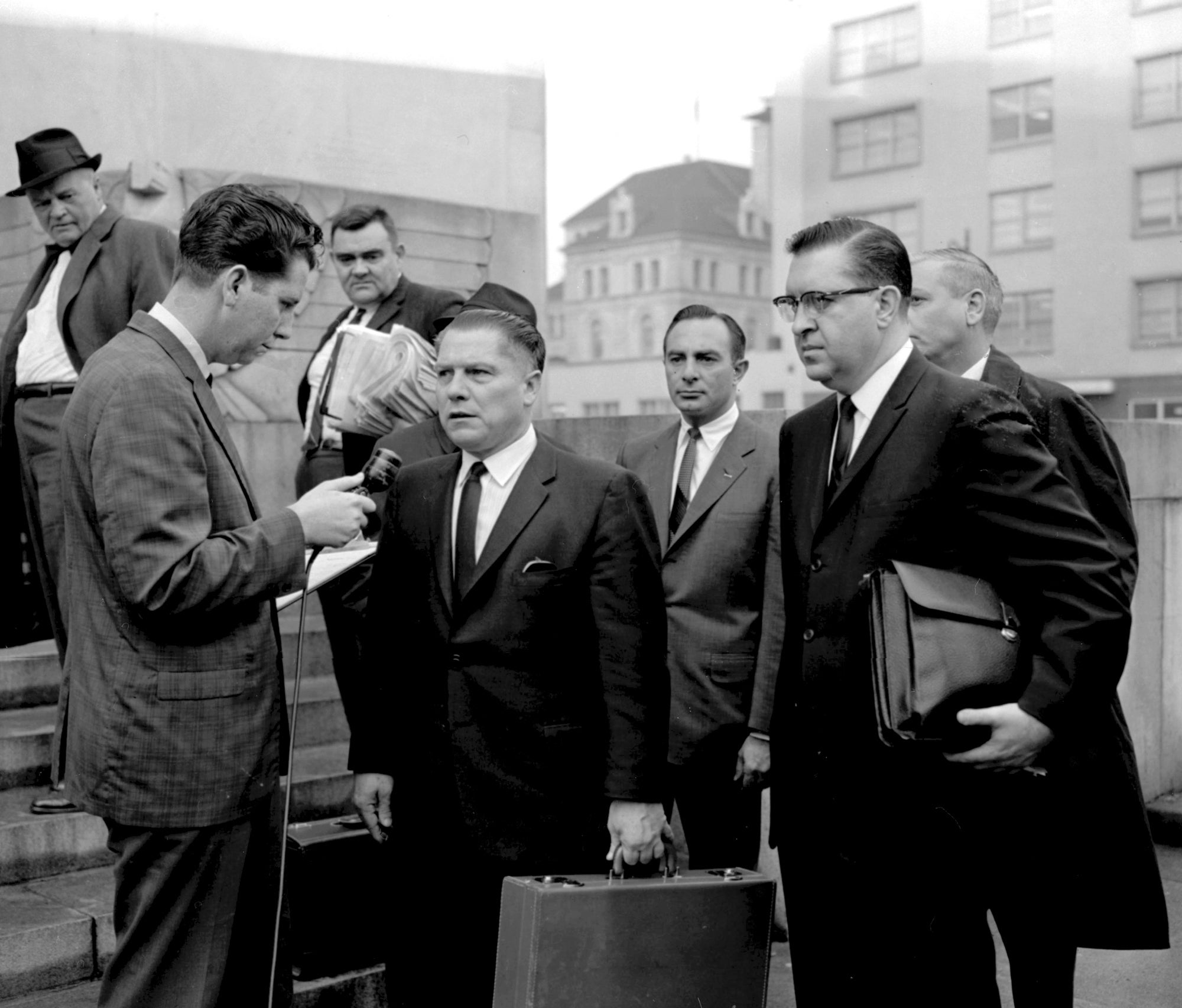 A reporter questions Teamsters general president Jimmy Hoffa outside of the federal courthouse in Chattanooga, Tennessee, in 1964 during his jury tampering trial