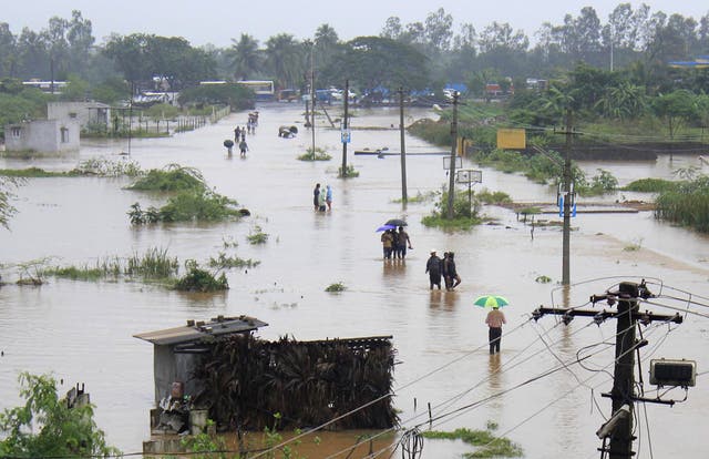 <p>File: Indian residents wade through flood waters in Visakhapatnam in the coastal district of Andhra Pradesh on November 5, 2012 </p>