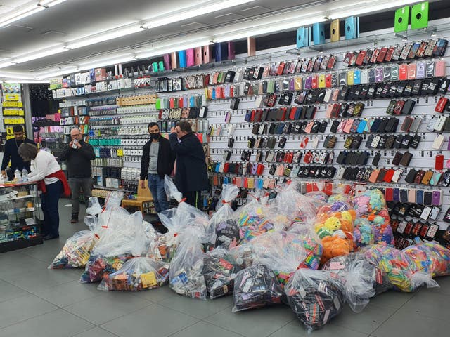 <p>Goods are seized by during a raid on a store on Oxford Street in London’s West End</p>