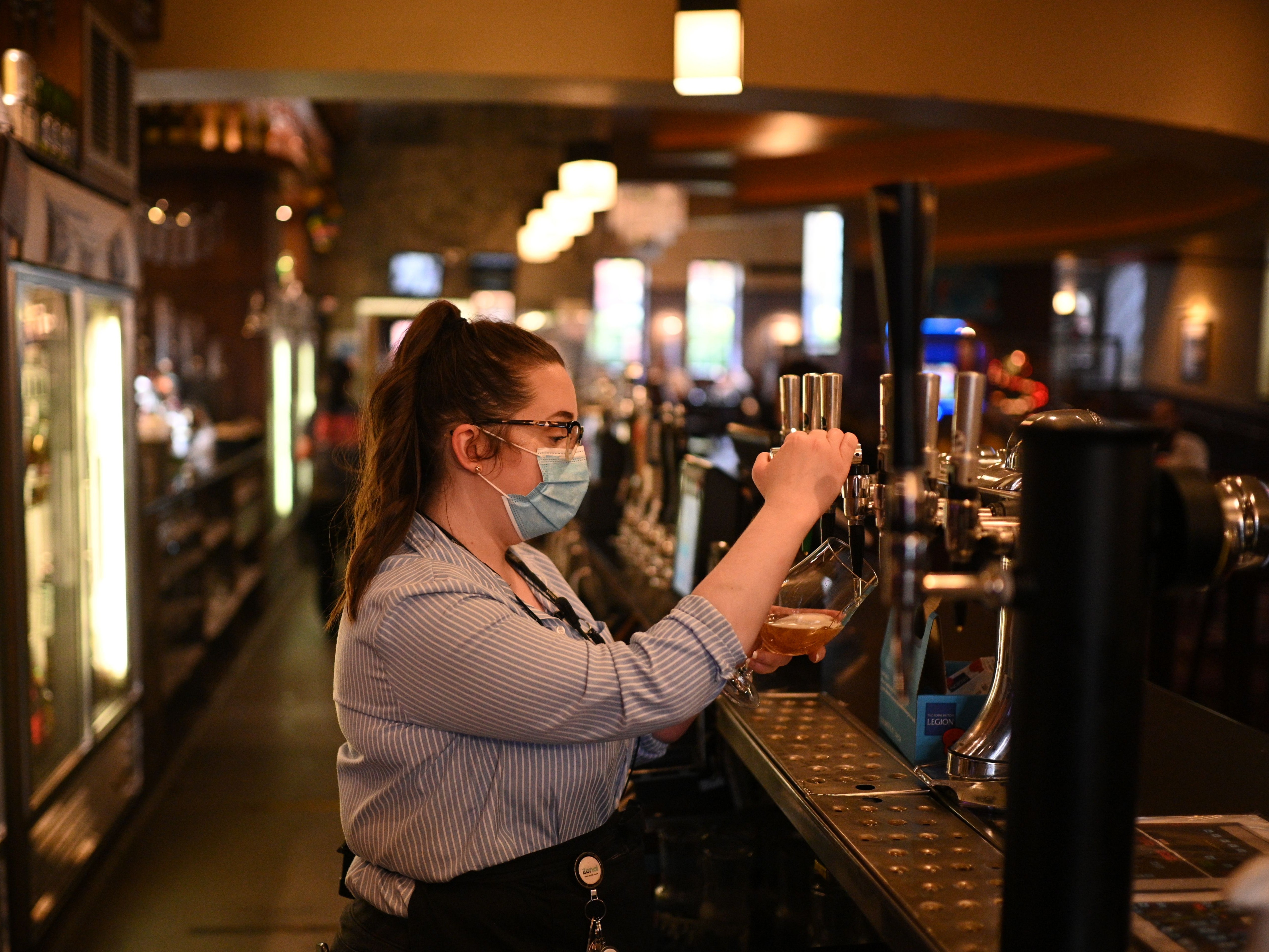 A member of staff pulls a pint in a Wetherspoons pub