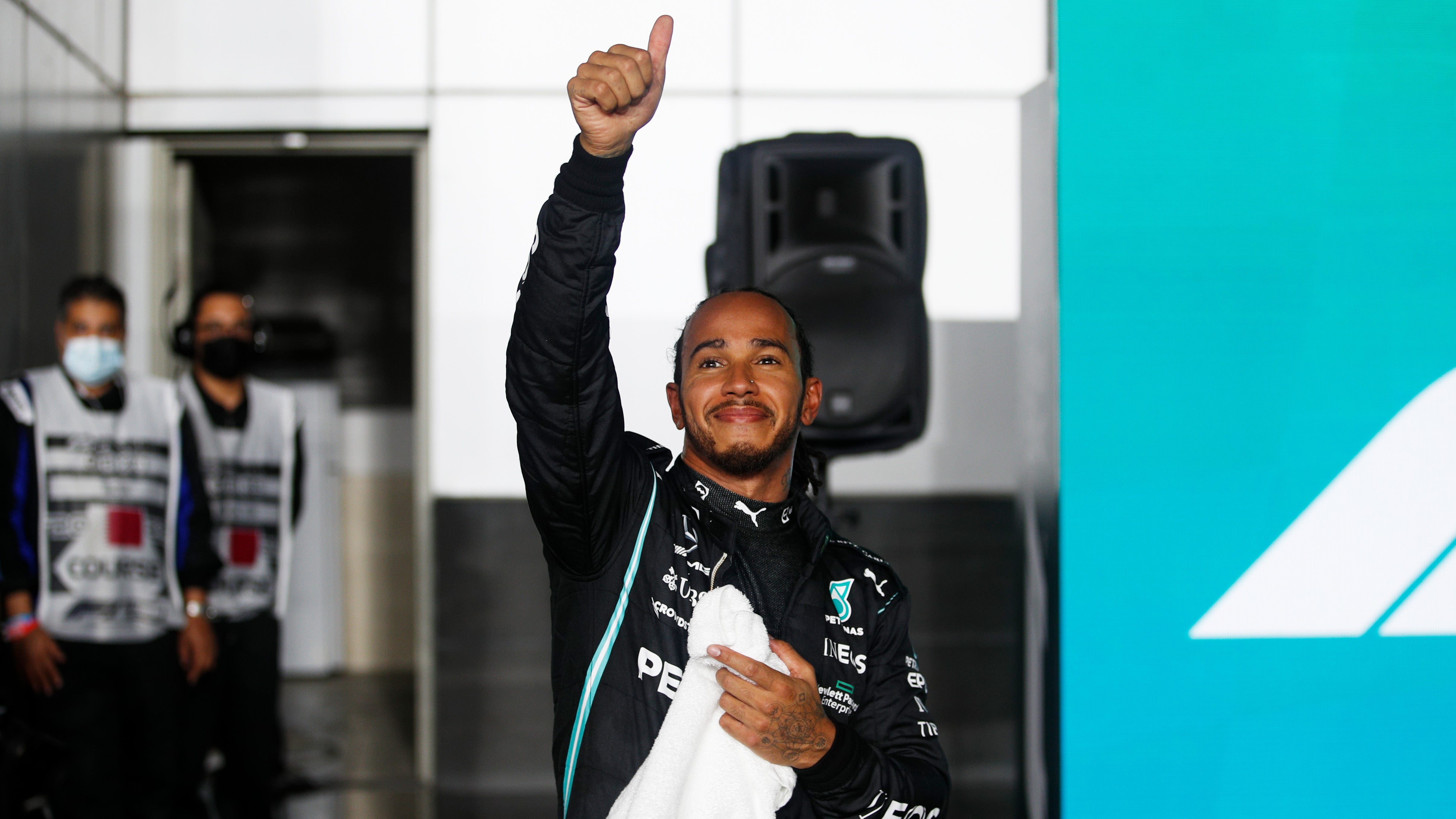 Pole position qualifier Lewis Hamilton of Great Britain and Mercedes GP waves to the crowd