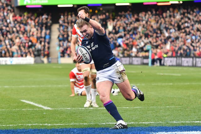 Scotland’s Stuart Hogg celebrates before scoring his record-breaking try (Malcolm Mackenzie/PA)