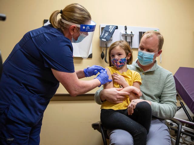 A seven-year-old girl gets a Covid jab in the US, which approved the Pfizer vaccine for younger children earlier this month