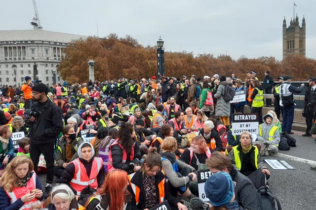 <p>Supporters of the jailed Insulate Britain protesters on Lambeth Bridge in London</p>