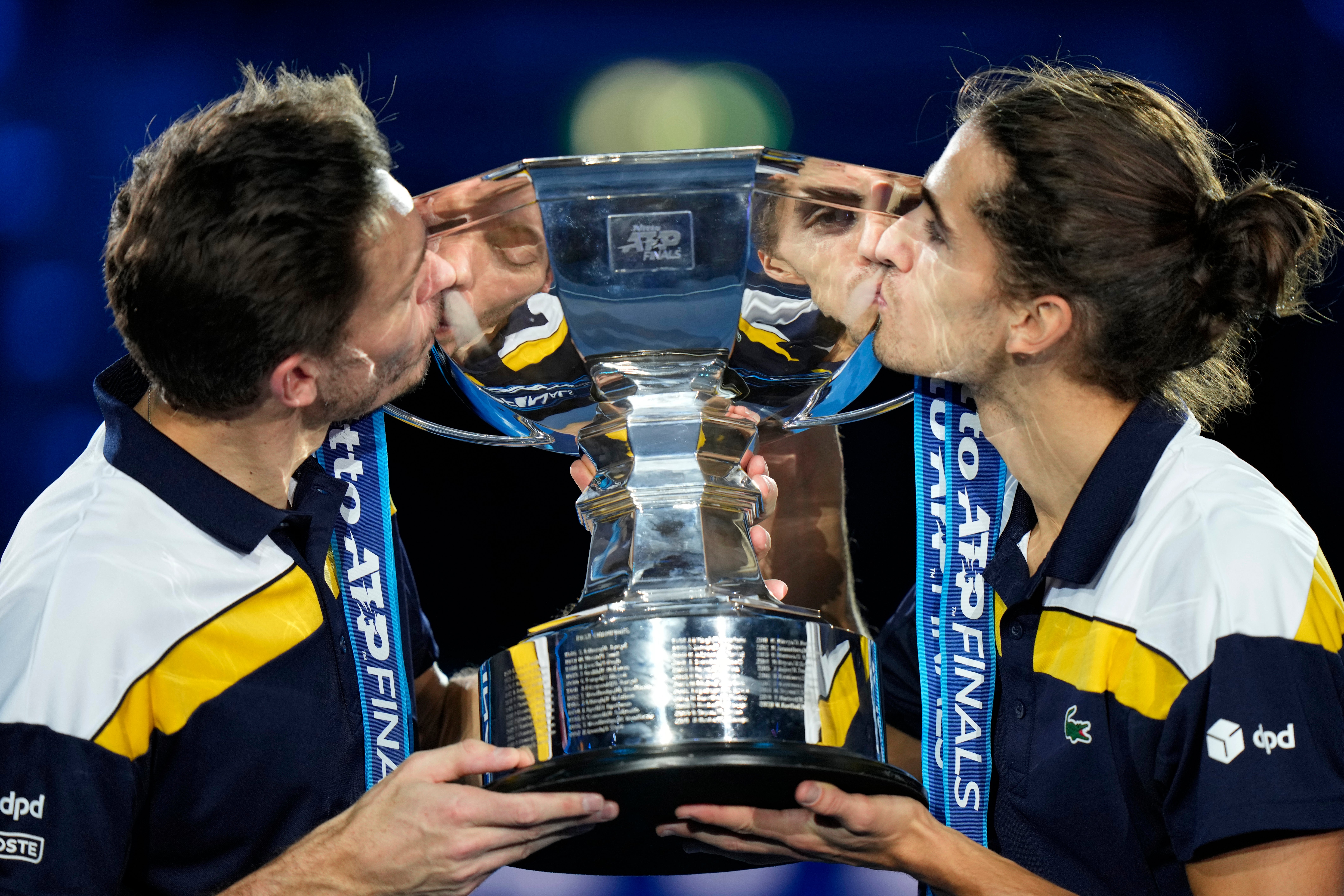 France’s Pierre-Hugues Herbert, right, and Nicolas Mahut kiss the trophy (Luca Bruno/AP)