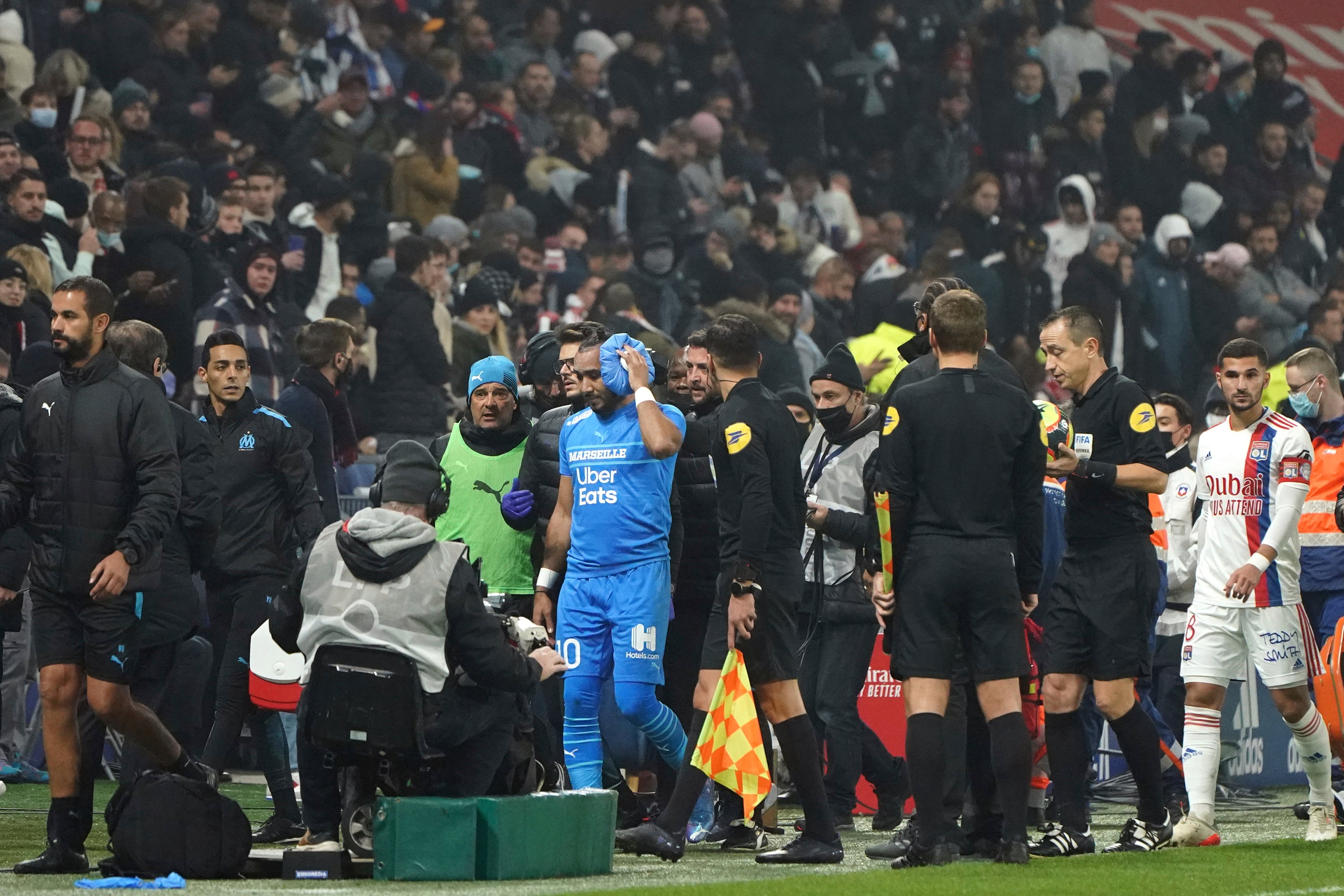 Marseille’s Dimitri Payet leaves the pitch after being hit by a bottle (Laurent Cipriani/AP)