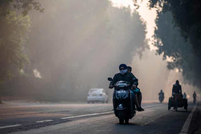 <p>Heavy smog conditions seen on a street in New Delhi on 19 November</p>