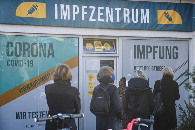 <p>People queue outside a vaccination centre in Berlin on Monday</p>