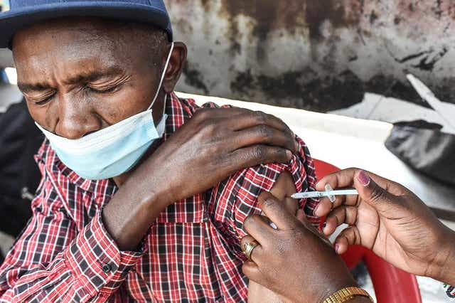 <p>A Kenyan man receives his Covid-19 vaccine in Nairobi</p>