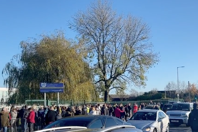 <p>Parents wait for their children outside of Golborne High School in Wigam</p>