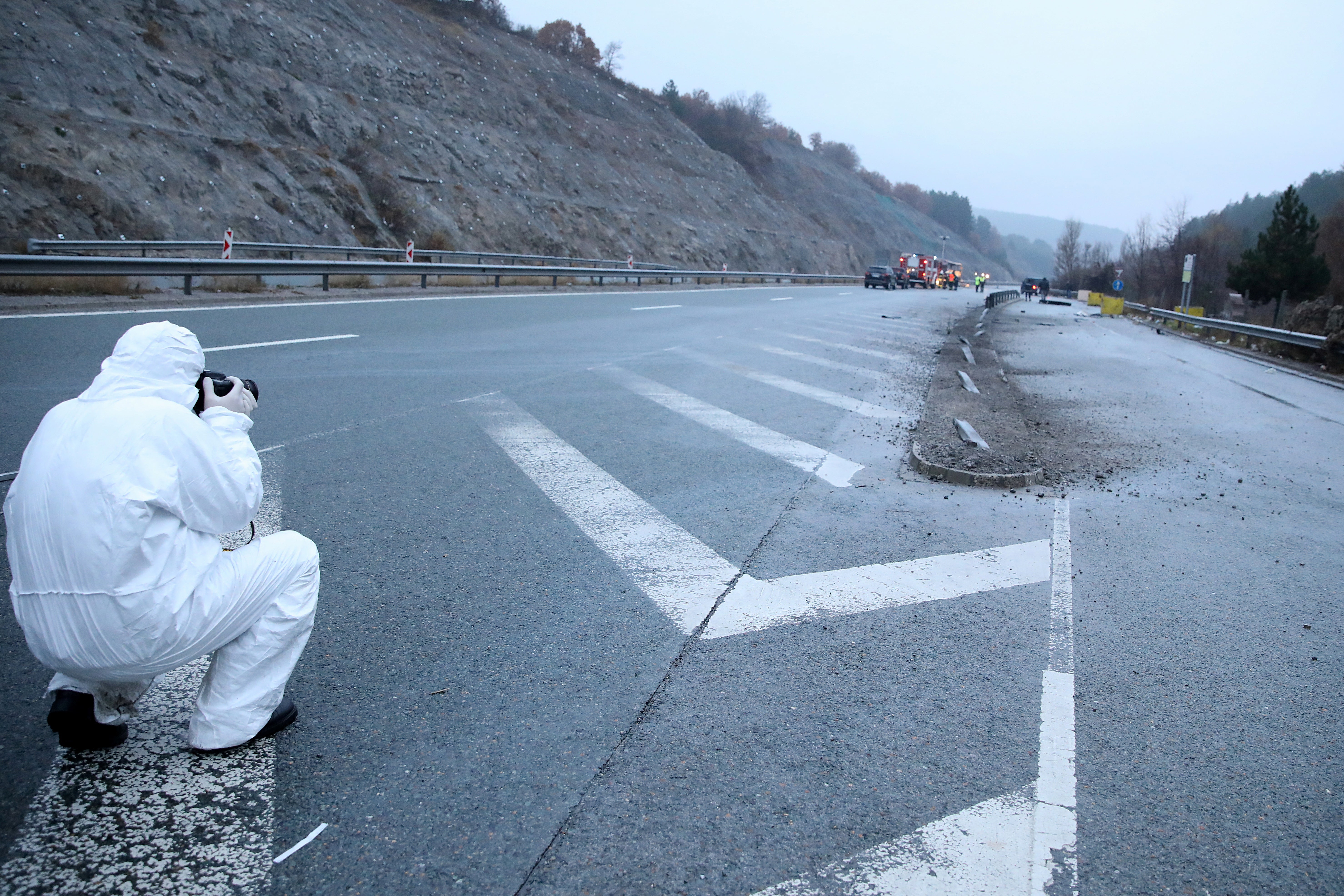 A forensic policeman at the site where the bus caught fire