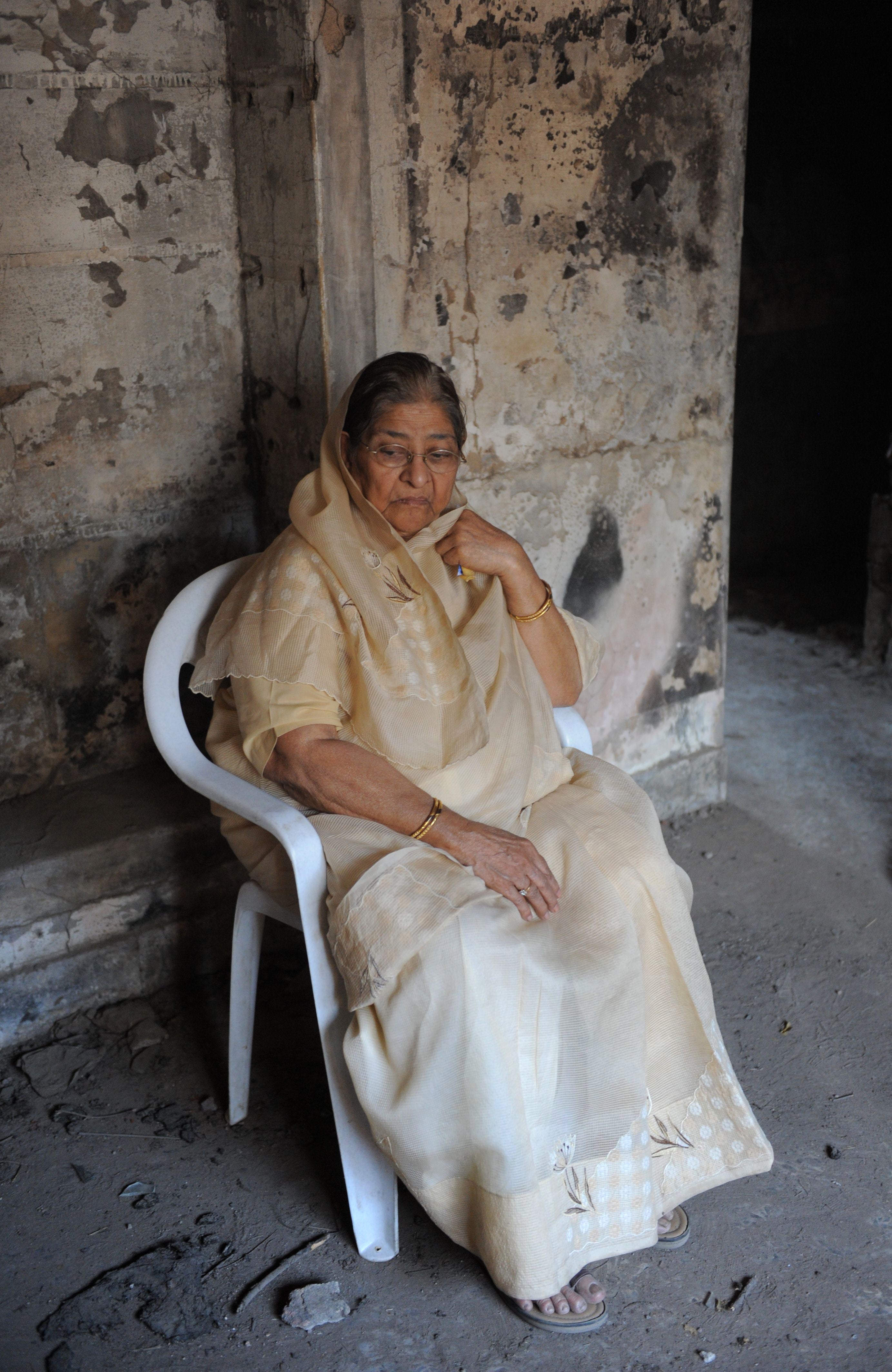 In this photograph taken on February 27, 2012 Zakia Jafri sits inside the remains of her former residence which was torched during the 2002 massacre at the Gulberg Society in Ahmedabad.