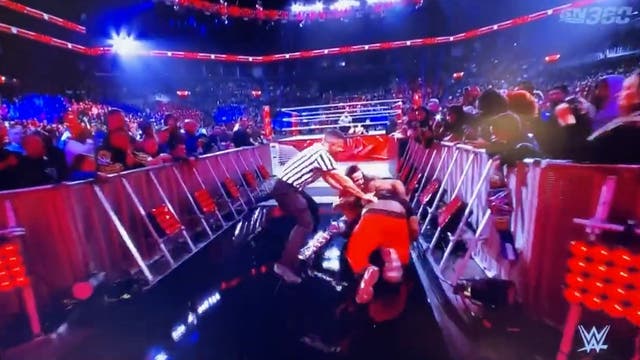 <p>A fan attacks wrestler Seth Rollins</p>