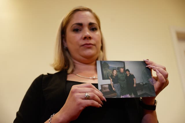 <p>Cuban Mavys Alvarez, who allegedly had a relationship with Argentinian soccer legend Diego Armando Maradona when she was 16, shows a photograph with Maradona during a press conference in Buenos Aires, Argentina, 22 November 2021.</p>