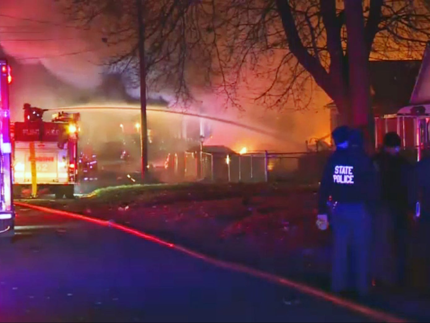 Fire crews try to extinguish flames from a house explosion in Flint, Michigan