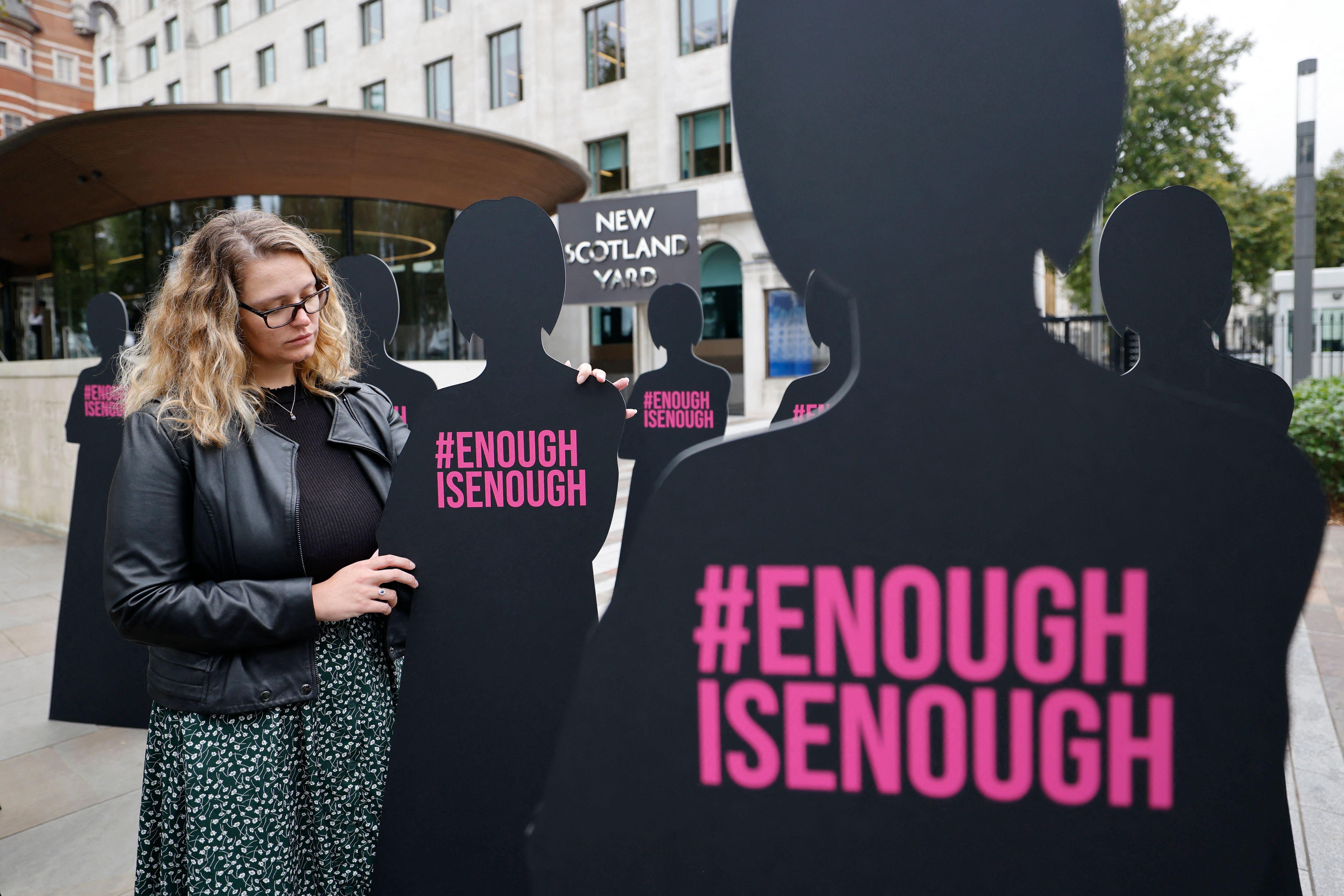 A campaigner outside New Scotland Yard in London on October 7, 2021, part of an action by Refuge, the domestic abuse charity