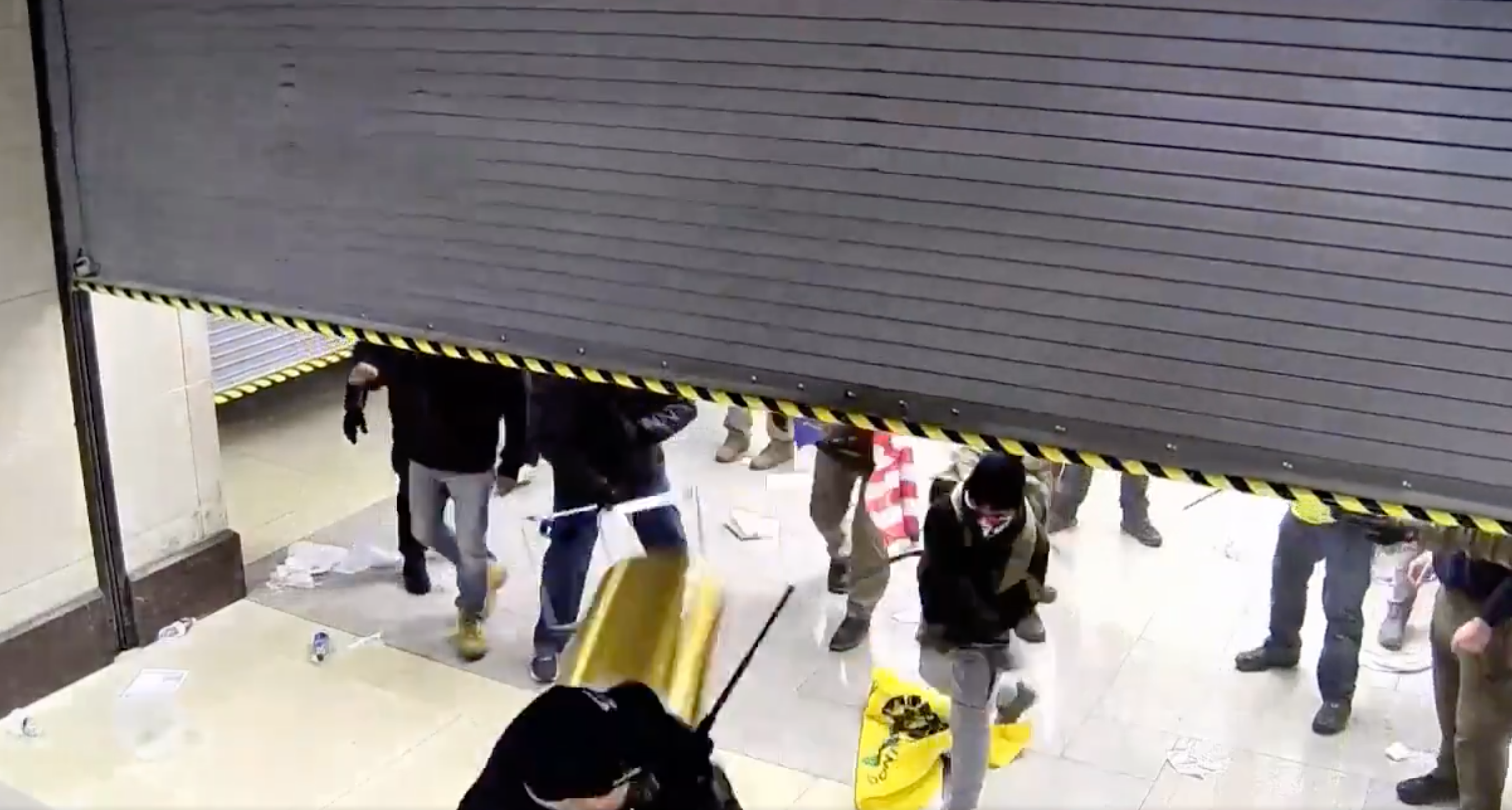 <p>A supporter of former President Donald Trump throws a trash can at a police officer during the Capitol riot on 6 January while trying to breach the US Capitol. </p>