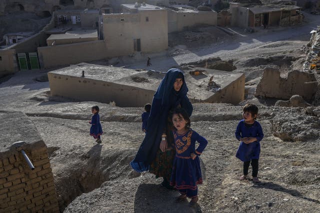 <p>Hazara ethnic woman and children stroll through a village in Bamiyan in central Afghanistan </p>