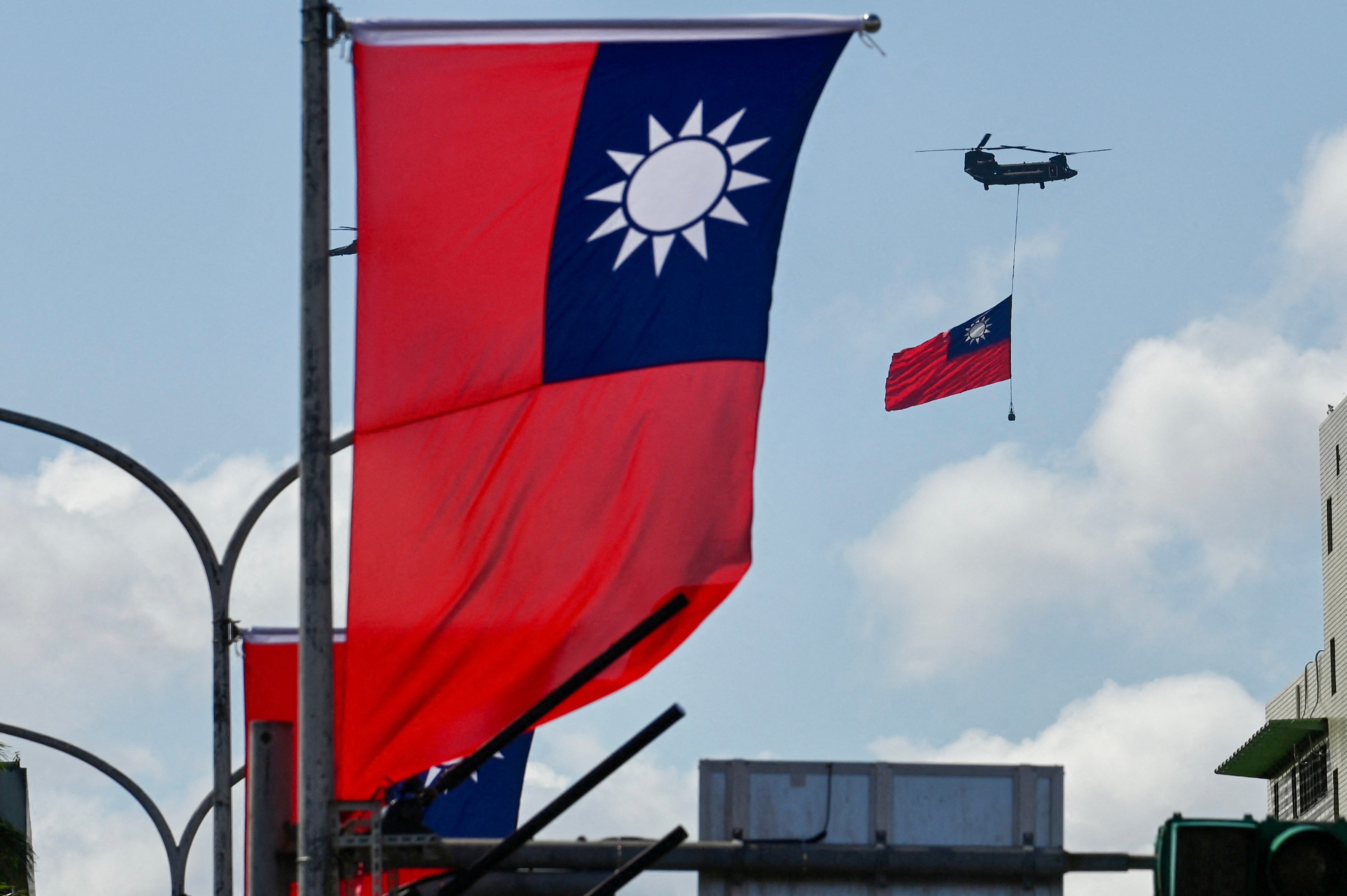 A CH-47 Chinook helicopter carries a Taiwan flag during national day celebrations in Taipei on 10 October 2021