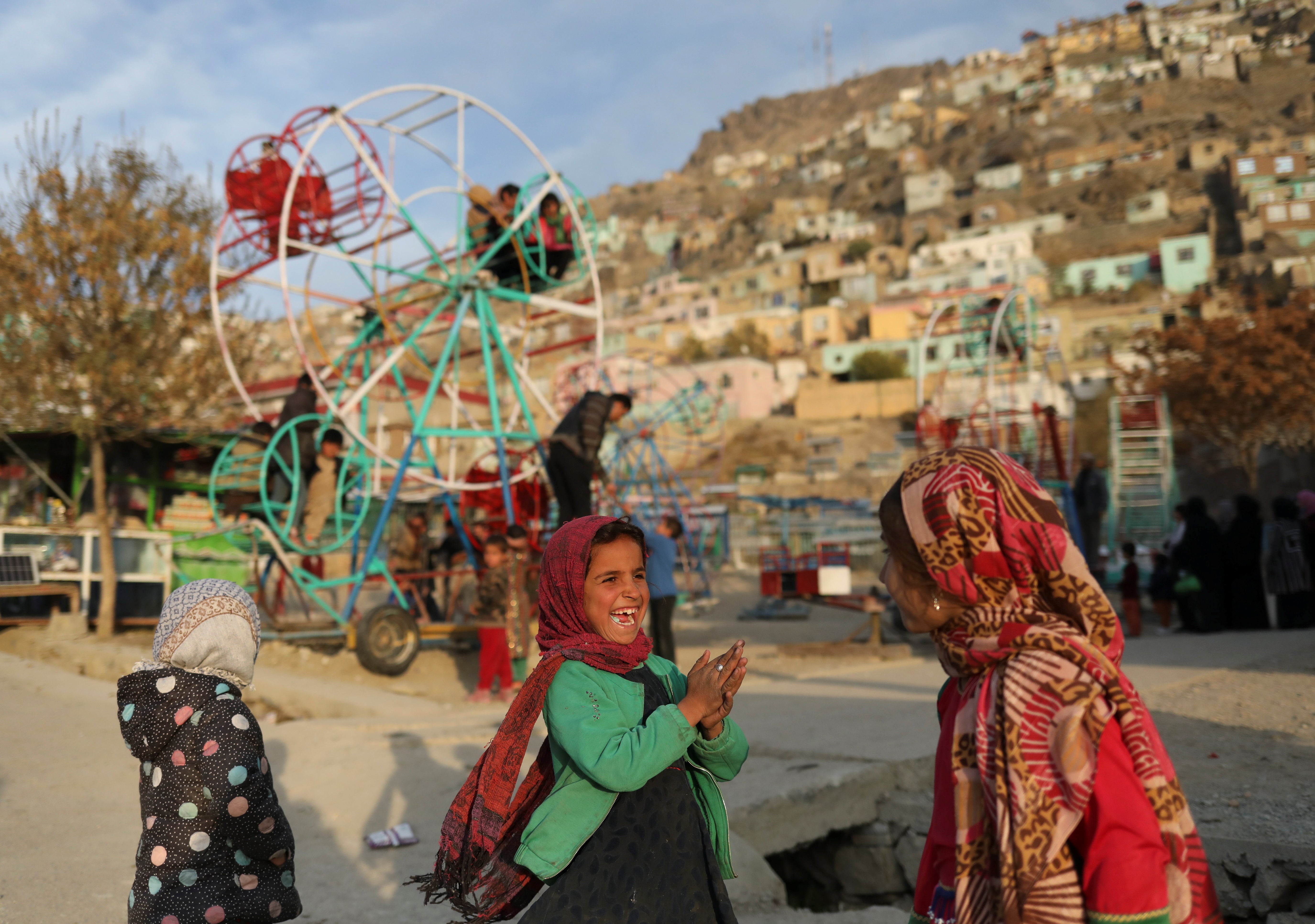 An Afghan child plays with her friend in Kabul, Afghanistan