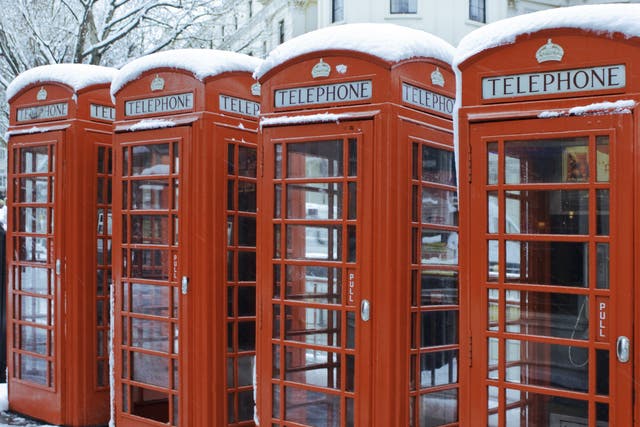 <p>Snow lines red telephone boxes in central London</p>
