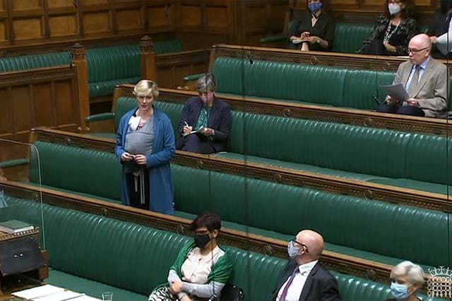 <p>Stella Creasy speaking with her newborn baby strapped to her in the chamber in September</p>