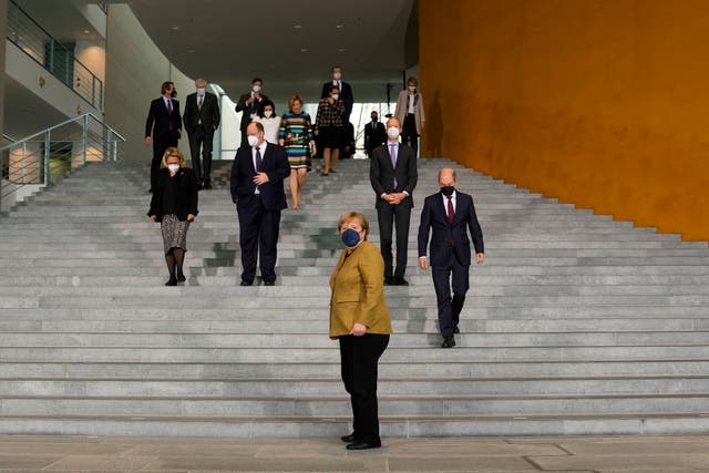 <p>German chancellor Angela Merkel arrives for a group photo with ministers and other members of her government after the cabinet meeting at the Chancellery on Wednesday</p>