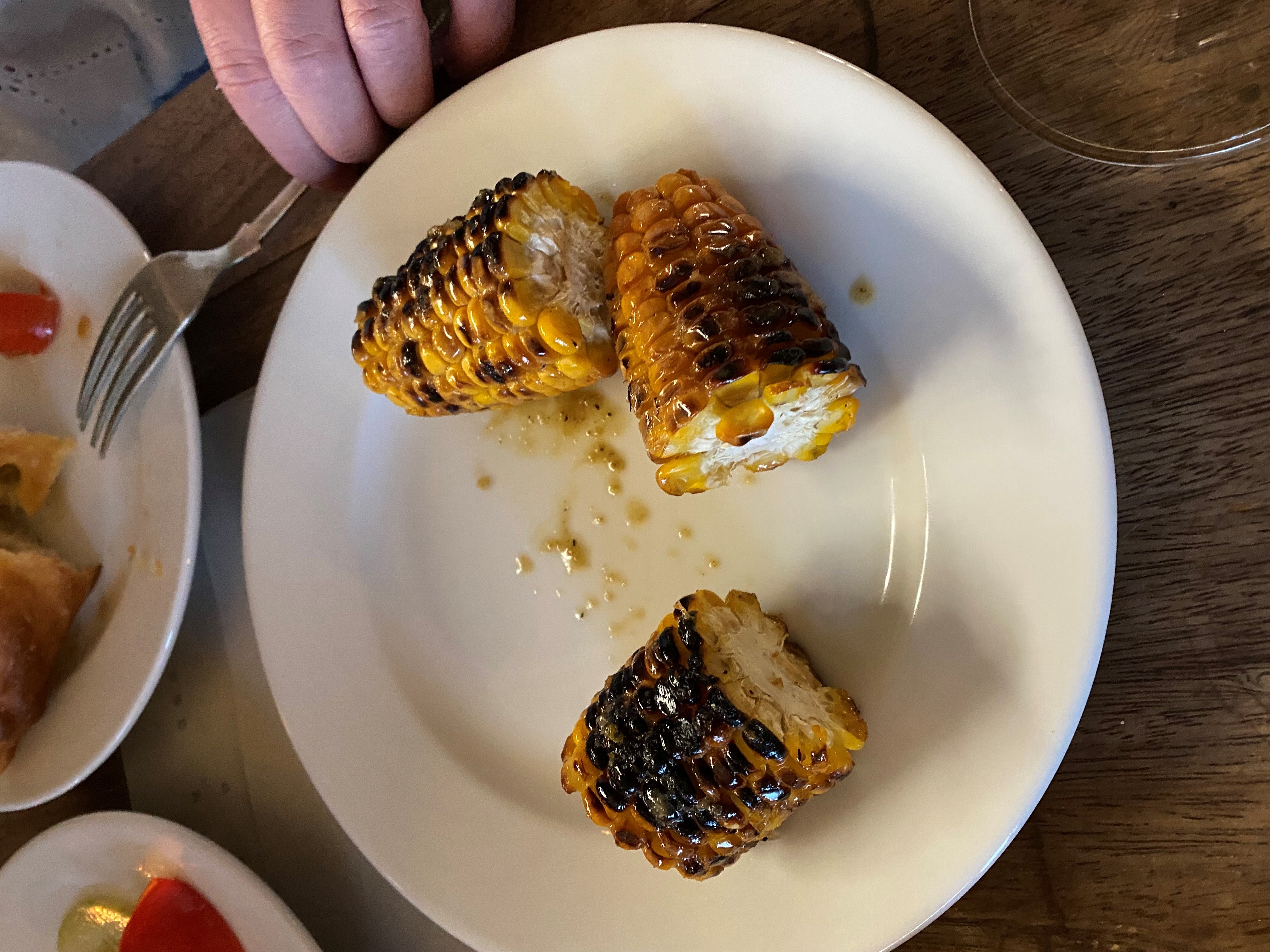 Grilled corn rolled around the plate like forlorn bottles at the footwell of a speeding car