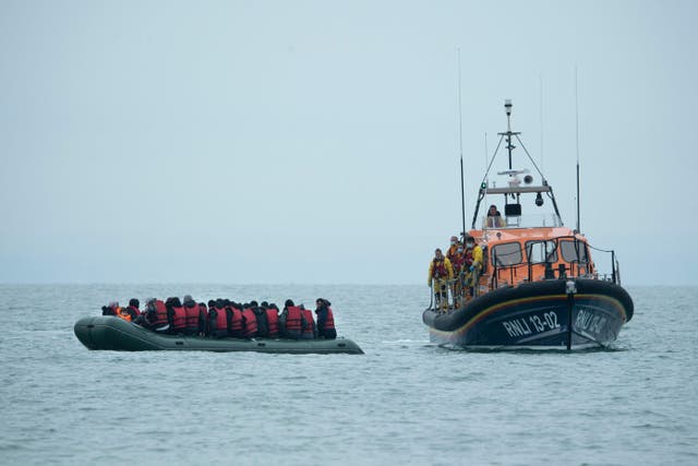 <p>Migrants are helped by RNLI off the south-east coast of England on 24 November</p>