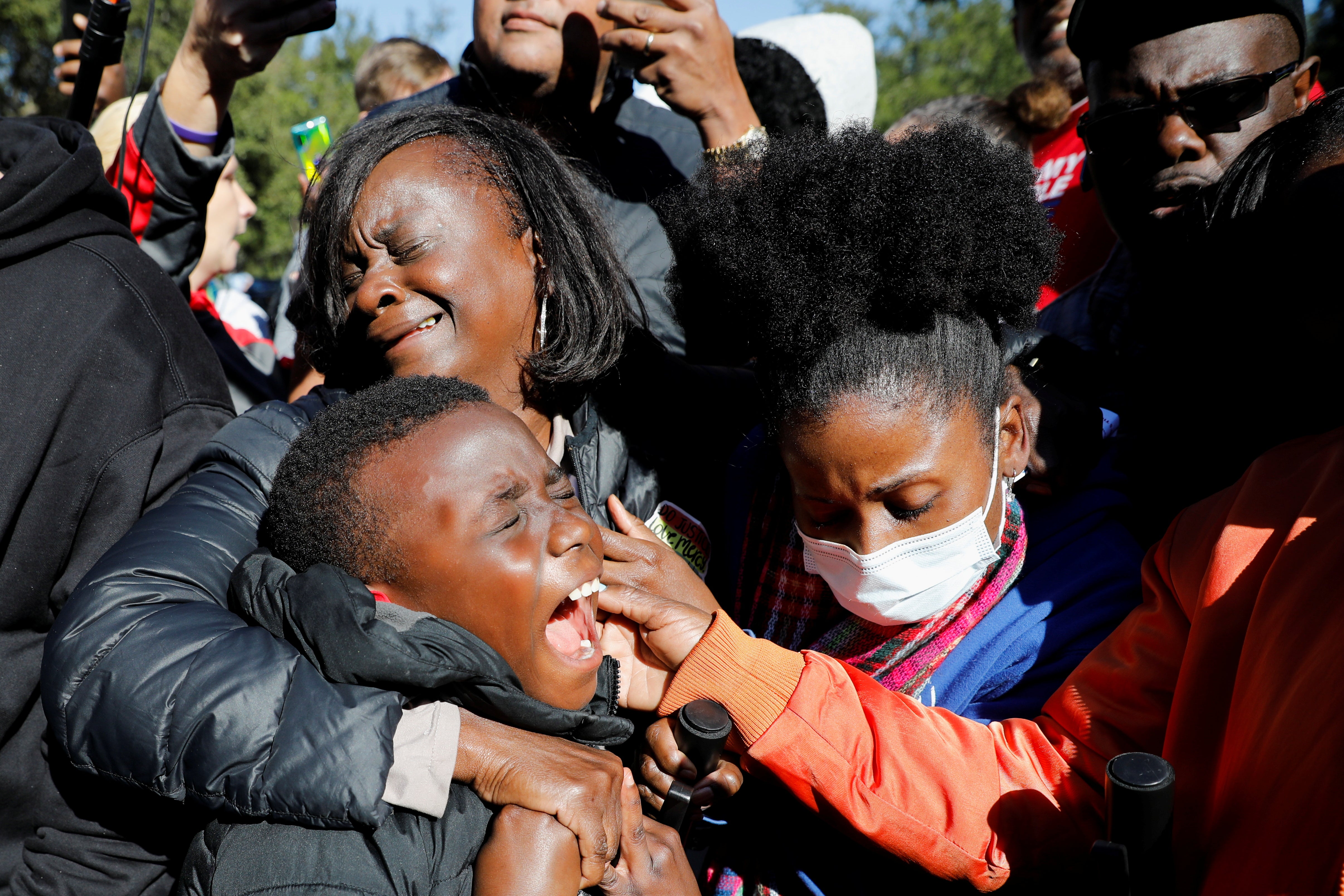 <p>People react outside the Glynn County Courthouse after the jury reached a guilty verdict in the trial of William "Roddie" Bryan, Travis McMichael and Gregory McMichael, charged with the February 2020 death of 25-year-old Ahmaud Arbery, in Brunswick, Georgia</p>