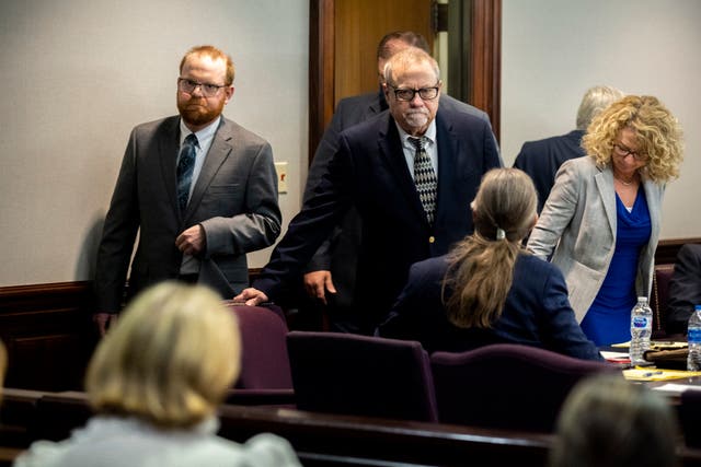 <p>File: Greg McMichael, centre, and his son, Travis McMichael, left, look at family members seated in the gallery when they walk into the courtroom for the reading of the jury’s verdict in November </p>