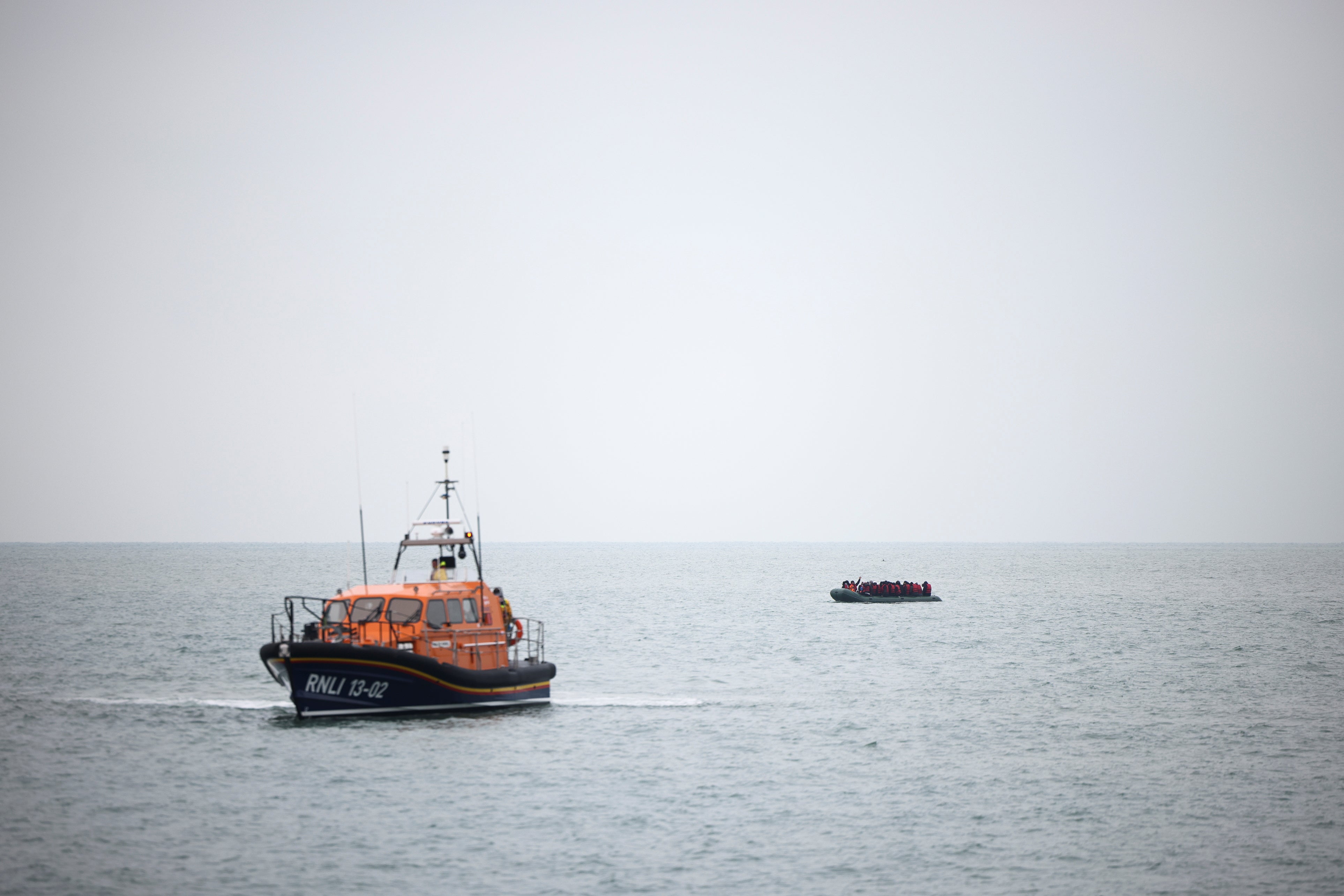 Migrants are escorted ashore by a RNLI Lifeboat