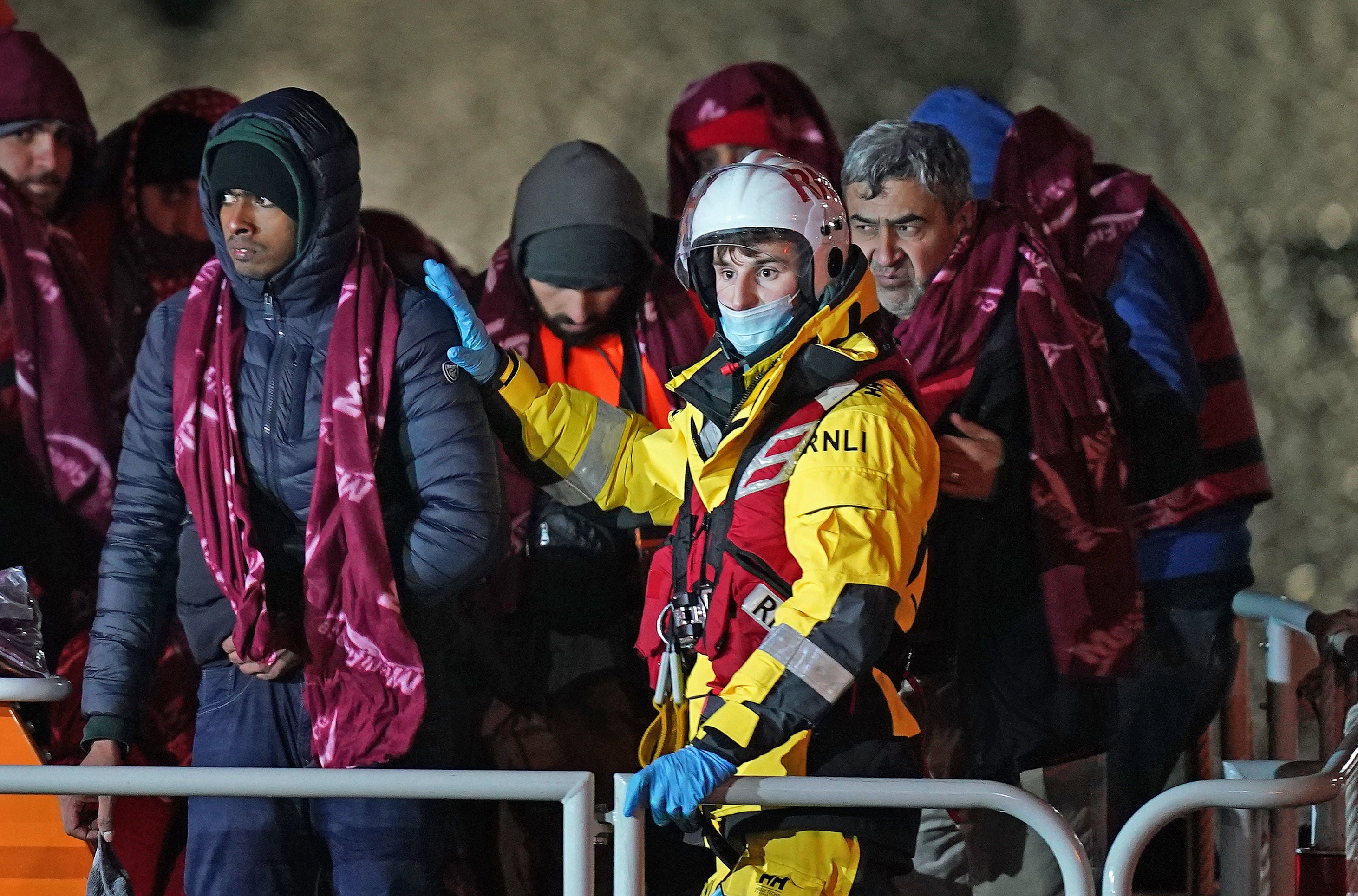 A group of people thought to be migrants are brought in to Dover, Kent, by the RNLI on Thursday