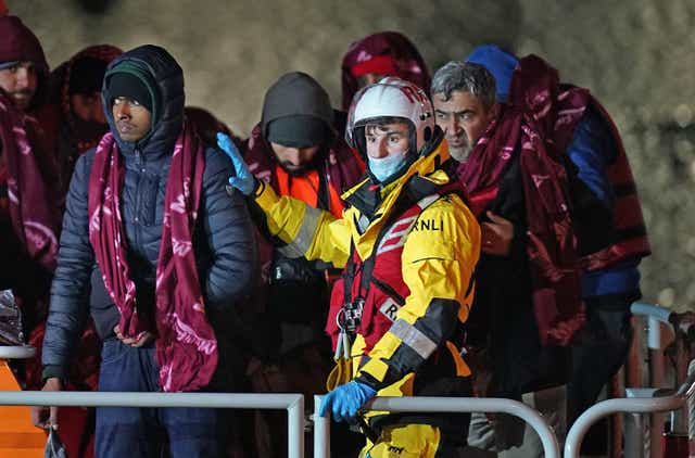 <p>A group of people thought to be migrants are brought in to Dover, Kent, by the RNLI on Thursday</p>