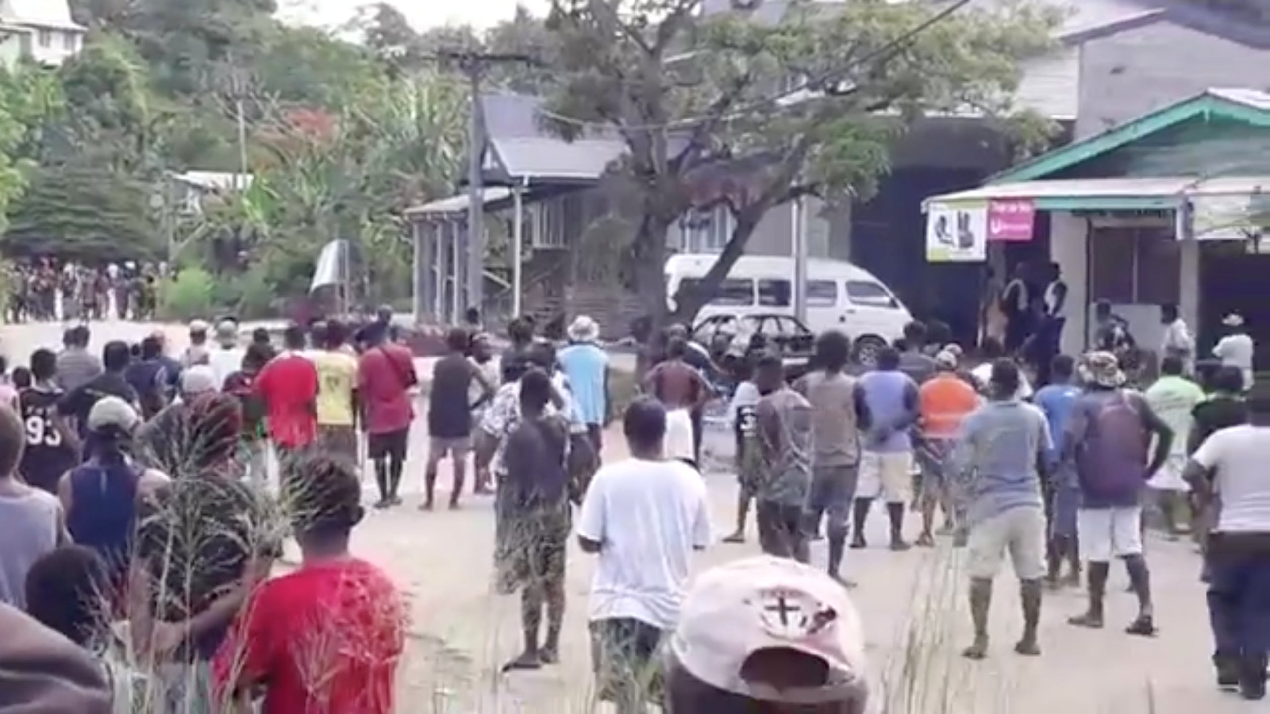 People gather near Naha police station as islanders defy curfew in the capital