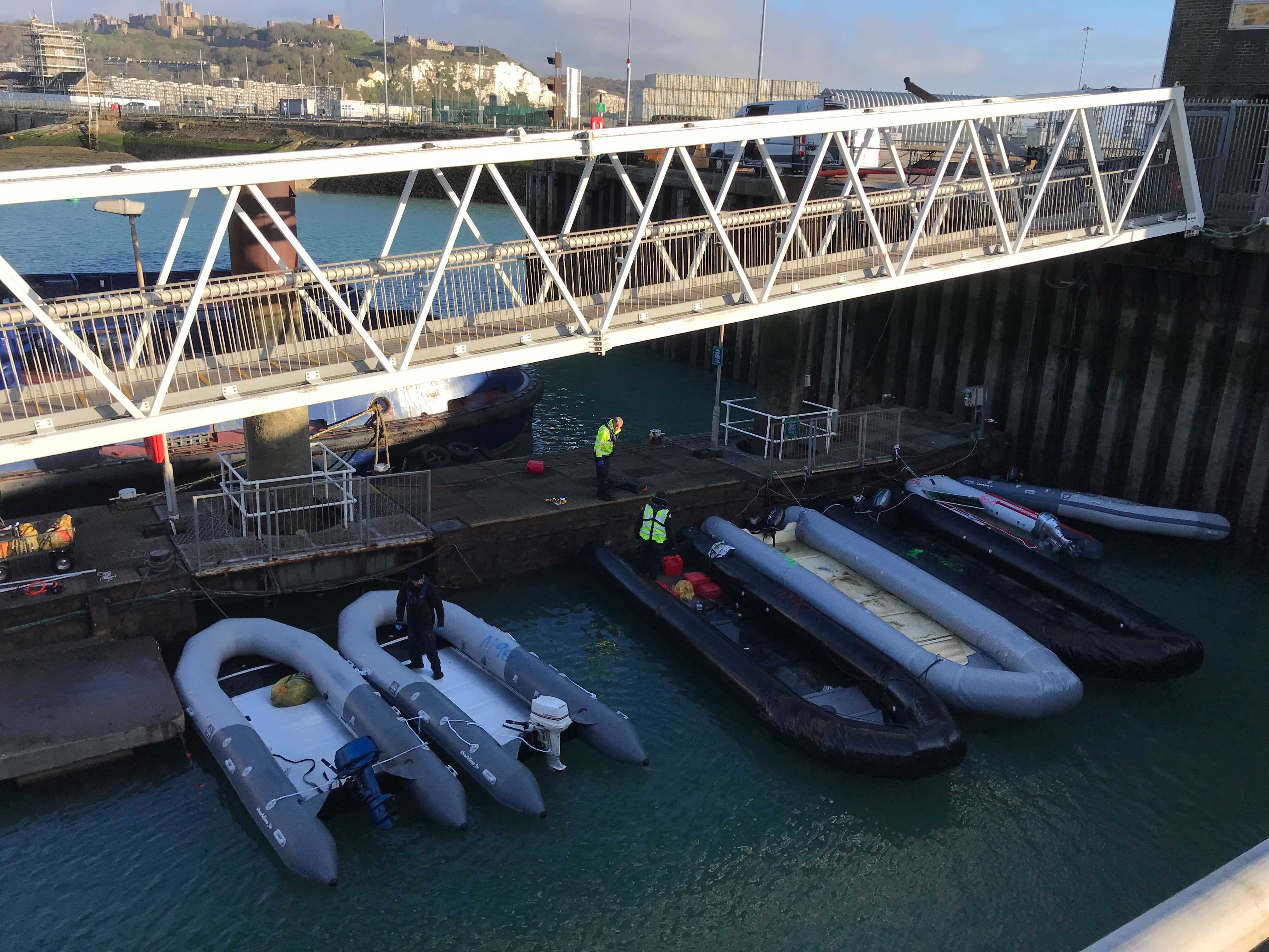 Border officials inspect a number of confiscated dinghies, with the two on the left believed to have been used in the Channel crossing on Thursday morning.